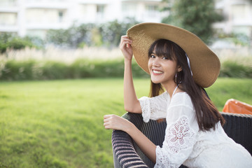 Young beautiful girl happy and relaxing on the armchair, Hua Hin, Thailand