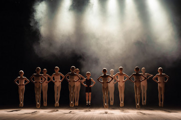Young ballerinas rehearsing in the ballet class. They perform different choreographic exercises and...