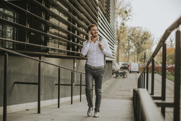 Stylish businessman walking outdoors