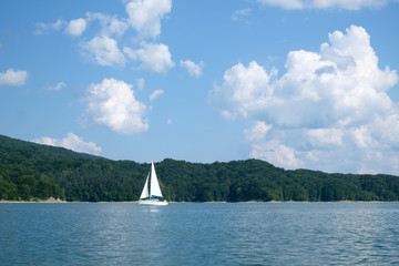 White yacht on Solina lake, Poland. Landscape photography