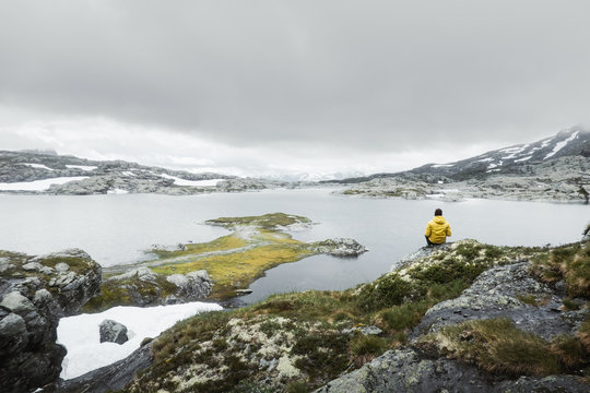 Typical norwegian landscape with snowy mountains and clear lake near the Trolltunga rock - most spectacular and famous scenic cliff in Norway