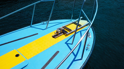 Fototapeta na wymiar Bow of a blue pleasure yacht against sea.