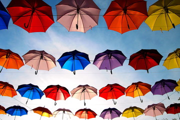 Fototapeta na wymiar A row of colorful umbrellas with blue sky background. 