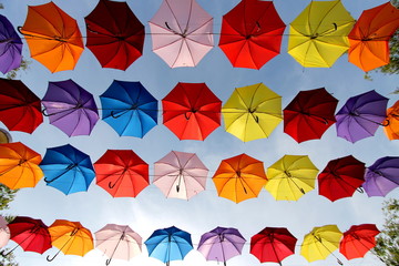 Fototapeta na wymiar A row of colorful umbrellas with blue sky background. 