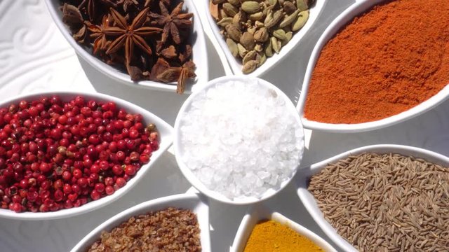 Dry spices on a rotary table. 4K. Macroshooting.