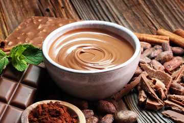 Melting chocolate  or melted chocolate with a chocolate swirl. Many stack and chips with powder.