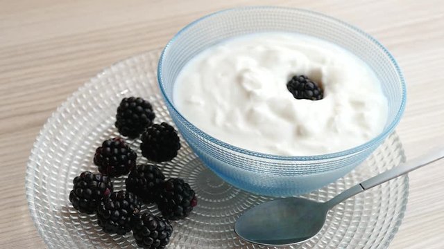 A healthy breakfast with homemade yogurt, blackberry and sugar sprinkles. Slow Motion video