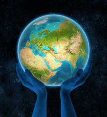 Azerbaijan on Earth in hands in space