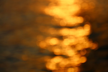 Blurry bokeh of the golden sunset sea