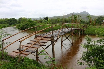A thin bamboo bridge for crossing over the river