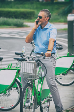 Man riding a city bicycle in formal style