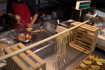 Folding dryer fresh pasta while baker preparing