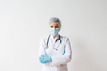 Portrait of a young female scientist or surgeon in white uniform on isolated background.
