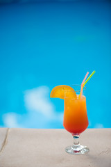 Cocktail next to swimming pool, summer vacation concept