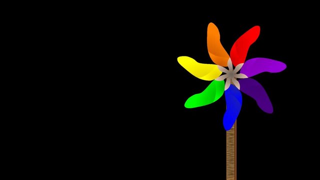 spinning VIBGYOR pin wheel on wooden stick against black background animation loop video