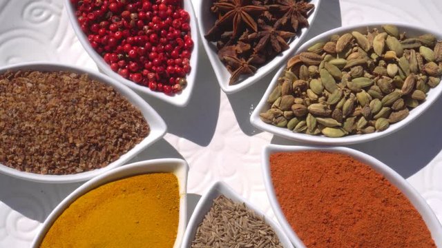 Dry spices on a rotary table. 4K. Macroshooting.