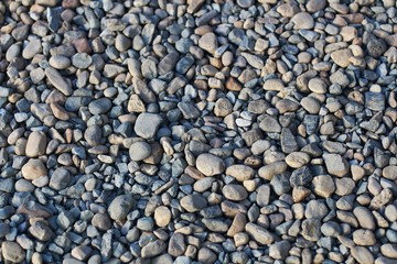 Background of the grey and brown round gravel on the floor