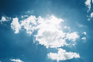 Naklejka na ściany i meble Blue sky with clouds and sun. Perfect background