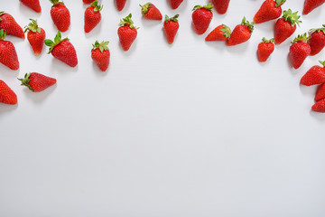 strawberry fruits on the above side on wooden background with copy space. View from above.