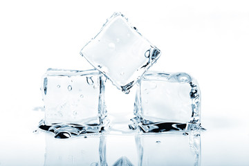 Three ice cubes melting isolated on white.