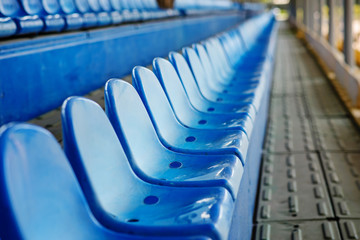 Empty plastic chairs in the stands of the stadium