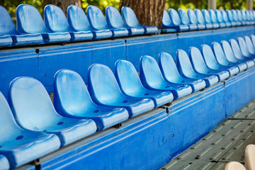Fototapeta premium Empty plastic chairs in the stands of the stadium