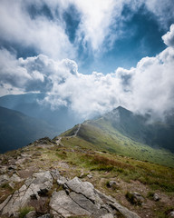 Scenic mountain view with dramatic low clouds at summer day in Tatra mountains, Poland