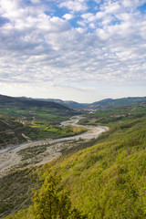 landscape of valley and his creek in emilia romagna hills