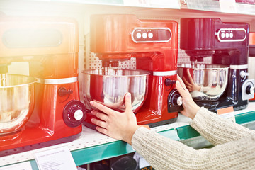 Woman selects electric food processor
