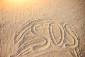The inscription on the sand beach SOS