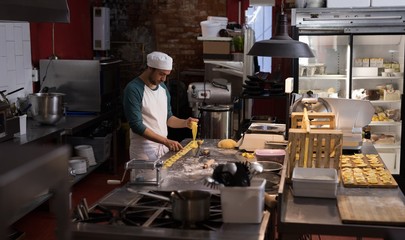 Male baker preparing for making pasta
