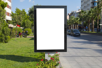 Blank mock up of vertical street poster billboard on city background
