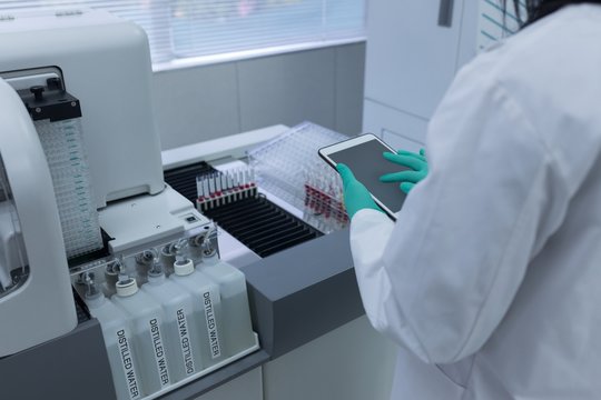 Laboratory technician using digital tablet