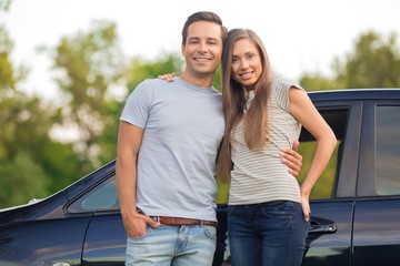 Obraz premium Portrait of a Smiling Couple by Car