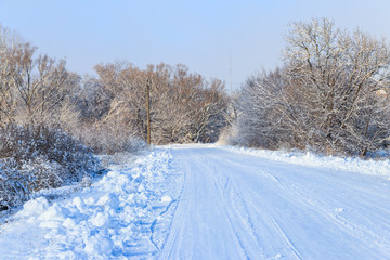 Snowy road after snowfall. Winter rural landscape