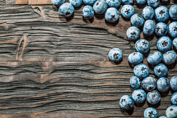 Heap of bilberries on vintage wooden background