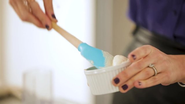 Scooping Out Batter From Overfilled Ramekin