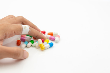 Colorful capsules tablets hold on hand. Image use for health care concept