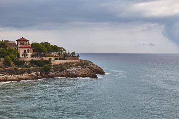 Fototapeta na wymiar Landscape of dramatic sea cliff with building Tarragona Spain