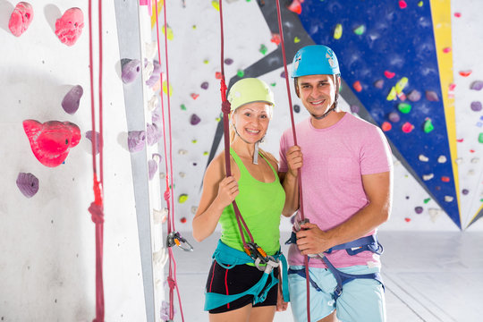 Two confident athletes at bouldering gym
