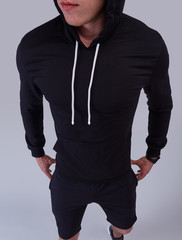 black hoodie with black shorts on man isolated