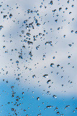 drops of a fountain against the sky