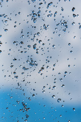 drops of a fountain against the sky