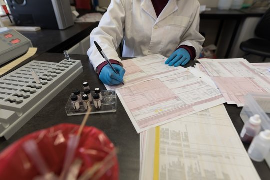 Laboratory technician checking invoices