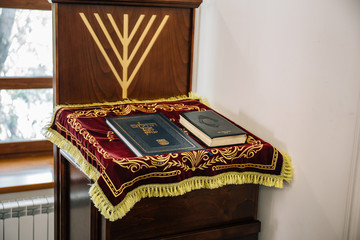 Synagogue inside with Torah books at stand