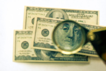 Souvenir hundred-dollar bills. Through the prism