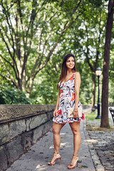 Fototapeta premium Beautiful Woman Walks down the Side Walk