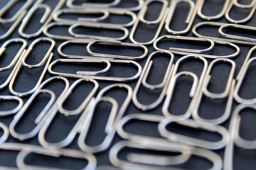 metallic paper clips silver color black background
