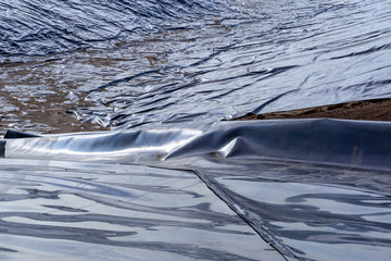 plastic underground waterproofing in the construction of a reservoir for the primary treatment of...