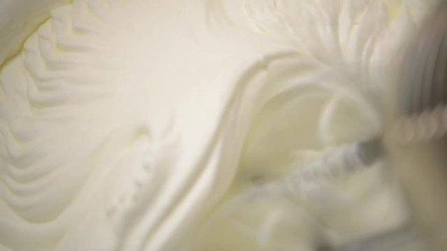 Making whip cream with orange chocolate and condensed milk. A man making home made ice cream in a kitchen.